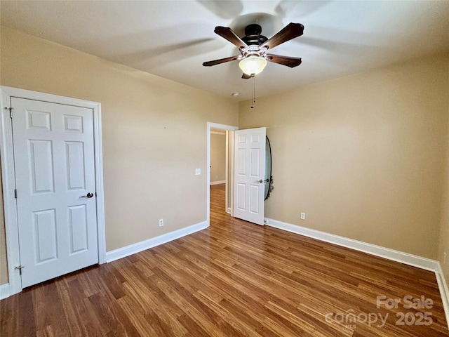 unfurnished bedroom with ceiling fan and wood-type flooring