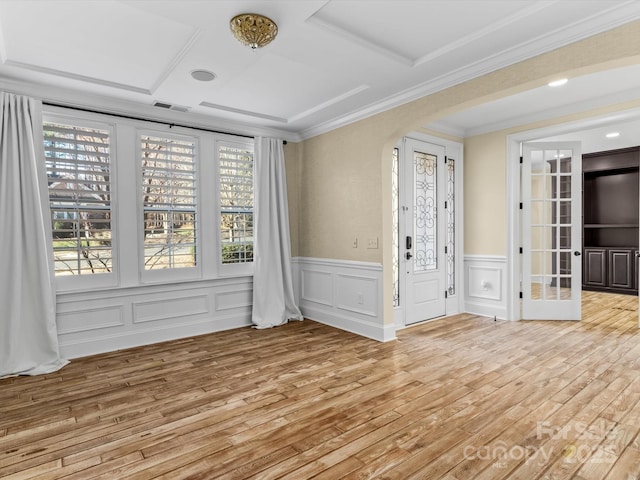 unfurnished room featuring coffered ceiling, crown molding, and light wood-type flooring