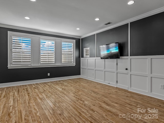 interior space with crown molding and light hardwood / wood-style flooring