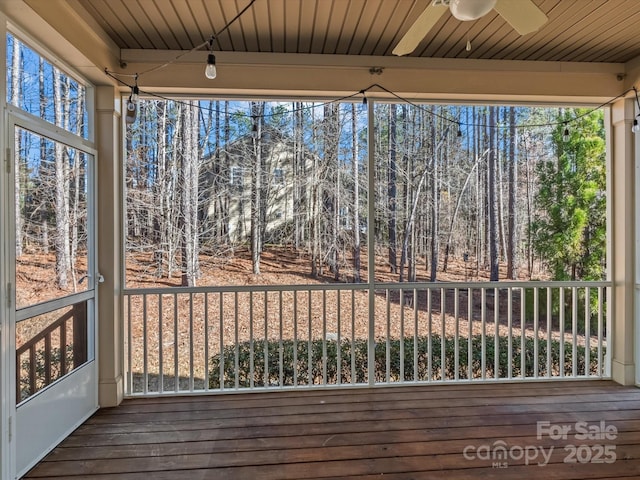 unfurnished sunroom with a wealth of natural light and ceiling fan