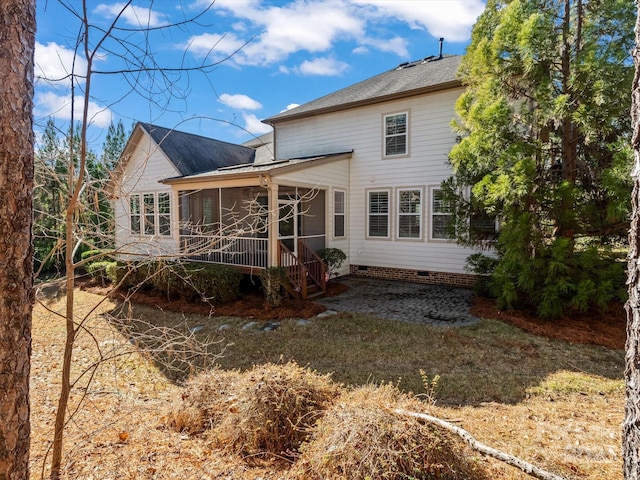 rear view of property featuring a sunroom