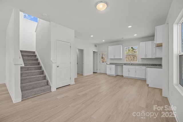 kitchen featuring recessed lighting, visible vents, baseboards, white cabinetry, and light wood finished floors