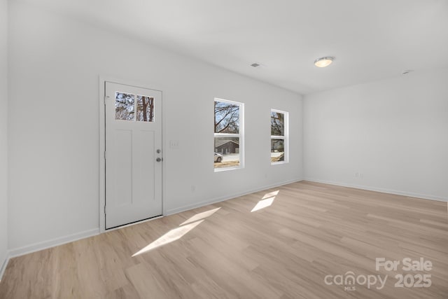 entrance foyer featuring light wood-type flooring and baseboards