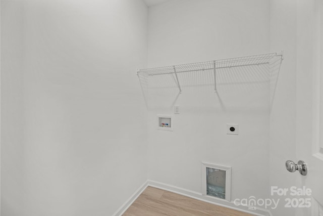 washroom featuring hookup for an electric dryer, laundry area, washer hookup, baseboards, and light wood finished floors