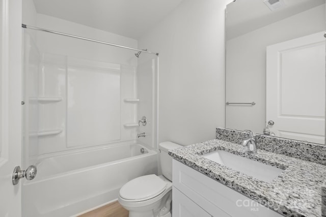 bathroom featuring toilet, wood finished floors, visible vents, vanity, and shower / washtub combination