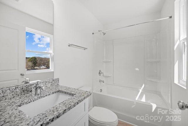 bathroom with shower / bathtub combination, vanity, and toilet