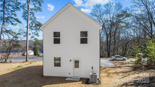 rear view of house featuring central AC