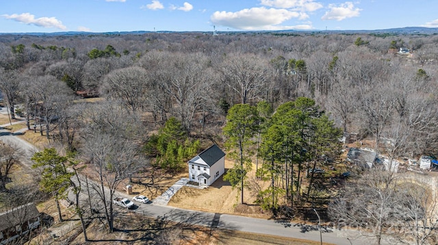 bird's eye view featuring a wooded view