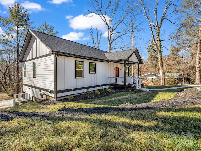 view of home's exterior with a yard and covered porch