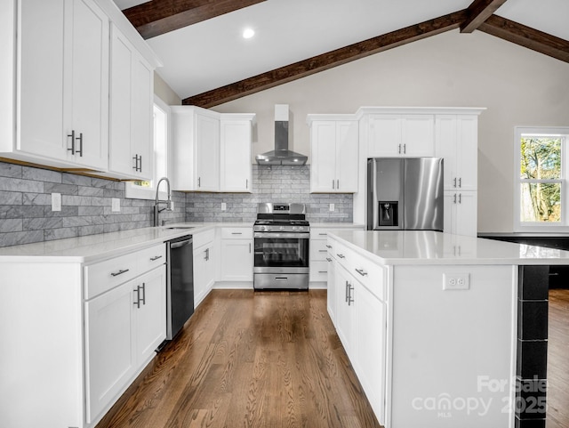 kitchen featuring wall chimney exhaust hood, white cabinetry, and stainless steel appliances