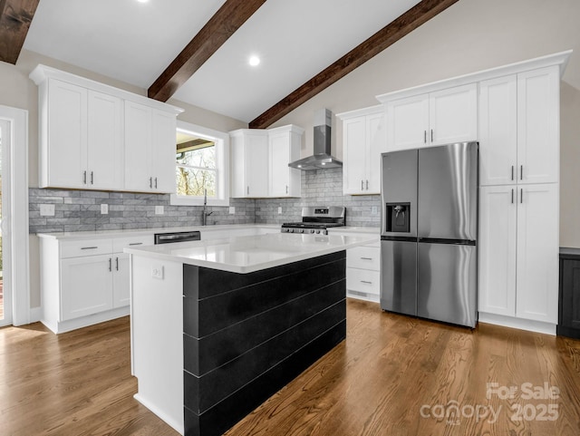 kitchen featuring white cabinetry, wall chimney exhaust hood, and appliances with stainless steel finishes