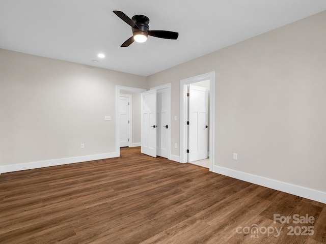 unfurnished bedroom featuring dark wood-type flooring and ceiling fan