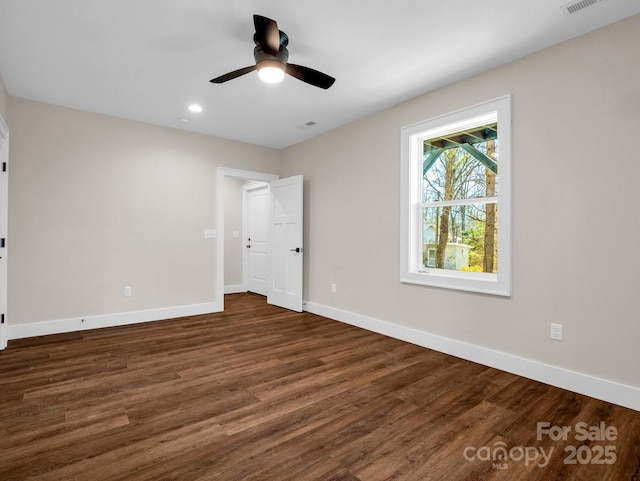 unfurnished room with dark wood-type flooring and ceiling fan