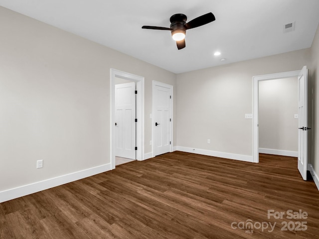 unfurnished bedroom with dark wood-type flooring and ceiling fan