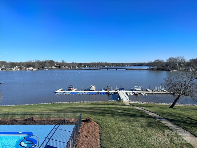 exterior space with a water view and a lawn