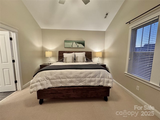 bedroom featuring vaulted ceiling, carpet flooring, visible vents, and baseboards