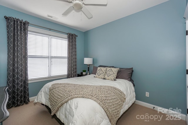 bedroom featuring carpet floors, baseboards, visible vents, and ceiling fan