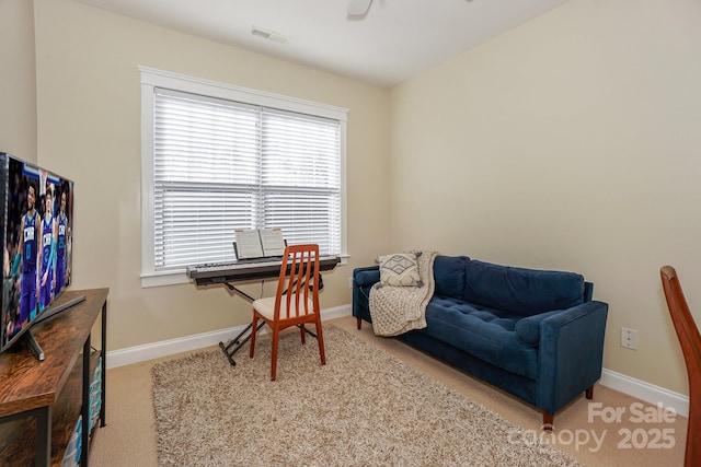 office featuring light colored carpet, visible vents, and baseboards