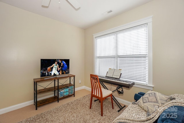 office area featuring ceiling fan, light colored carpet, visible vents, and baseboards