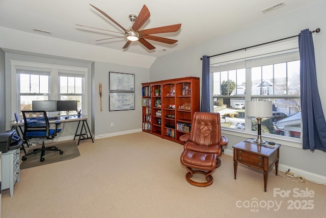 office area with visible vents, vaulted ceiling, light carpet, and baseboards