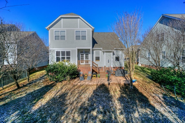 rear view of property with fence and a patio