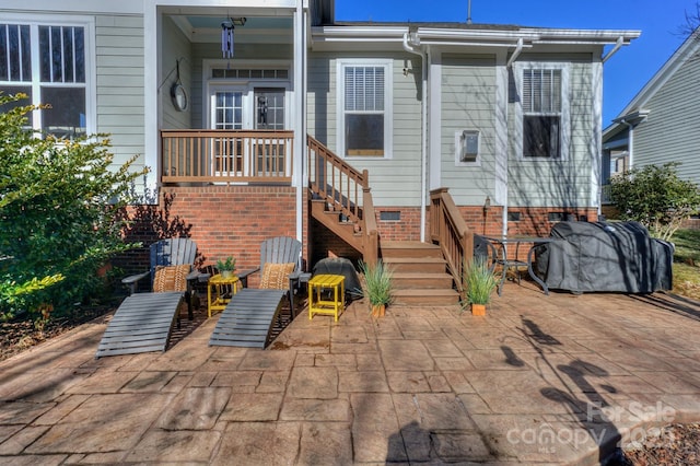 rear view of property featuring crawl space and a patio area