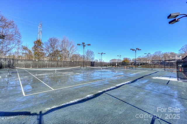 view of sport court featuring fence