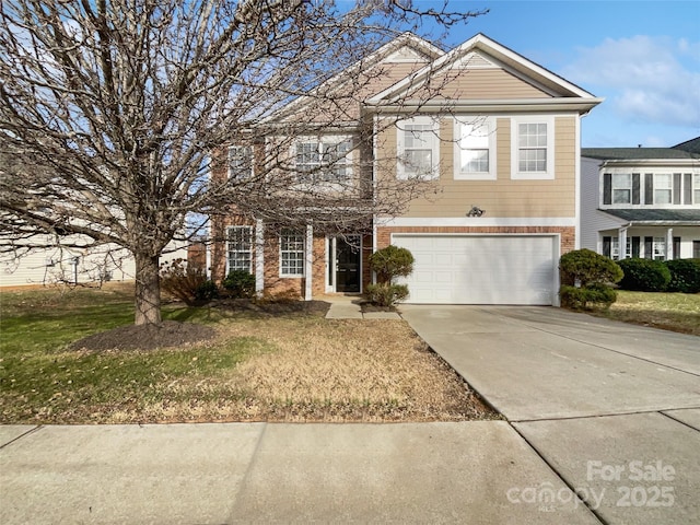 view of front of property featuring a front yard and a garage