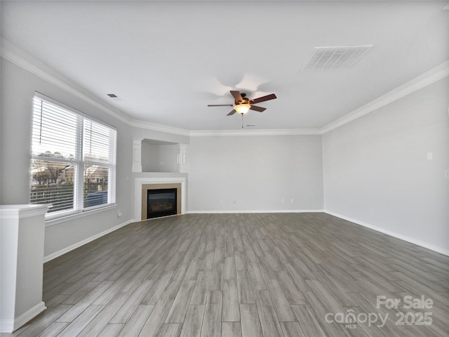 unfurnished living room featuring ceiling fan, wood-type flooring, and crown molding