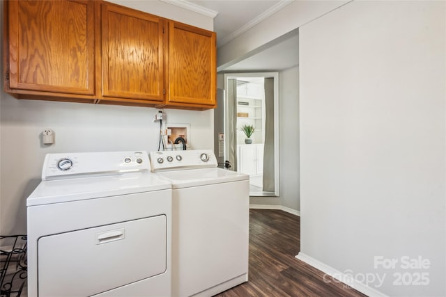 laundry area with cabinets, ornamental molding, dark hardwood / wood-style flooring, and washer and clothes dryer