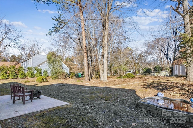 view of yard featuring a patio area and a fire pit