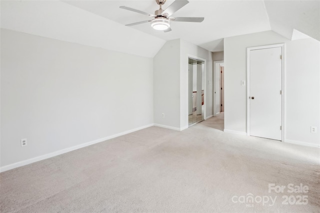 bonus room with vaulted ceiling, light colored carpet, and ceiling fan