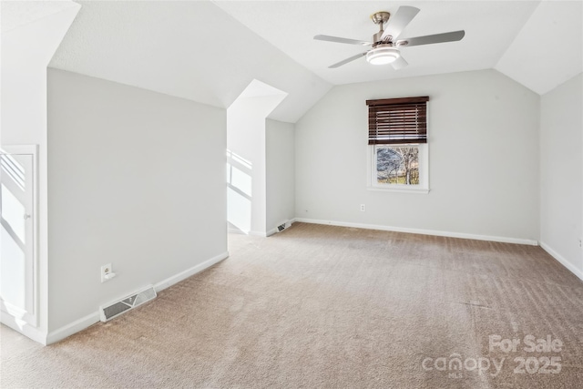 additional living space with lofted ceiling, light colored carpet, and ceiling fan