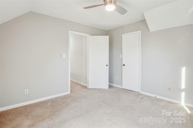 interior space with light carpet, vaulted ceiling, and ceiling fan