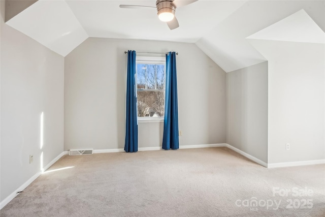 bonus room with lofted ceiling, light colored carpet, and ceiling fan