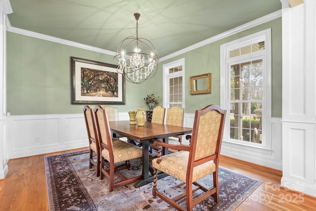 dining room with hardwood / wood-style floors, crown molding, and plenty of natural light