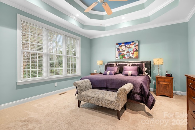 carpeted bedroom featuring crown molding, ceiling fan, and a tray ceiling