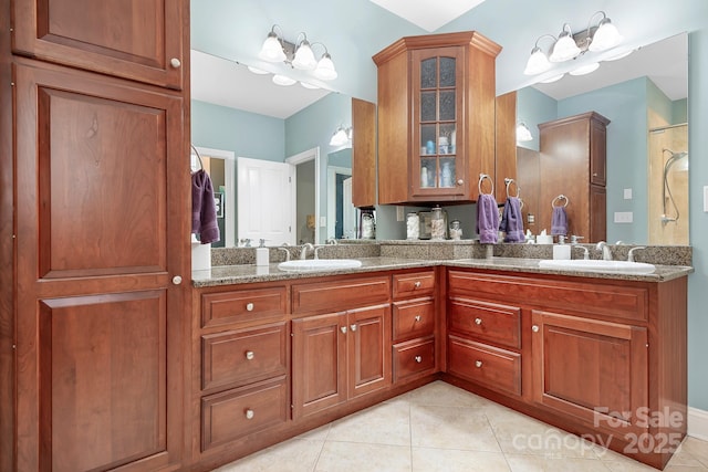 bathroom featuring vanity, tile patterned floors, and walk in shower