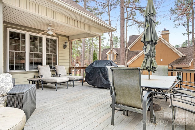 wooden terrace featuring a grill and ceiling fan