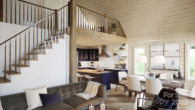 dining room featuring high vaulted ceiling, sink, and wood-type flooring