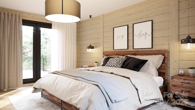 bedroom featuring access to exterior, wood walls, and multiple windows