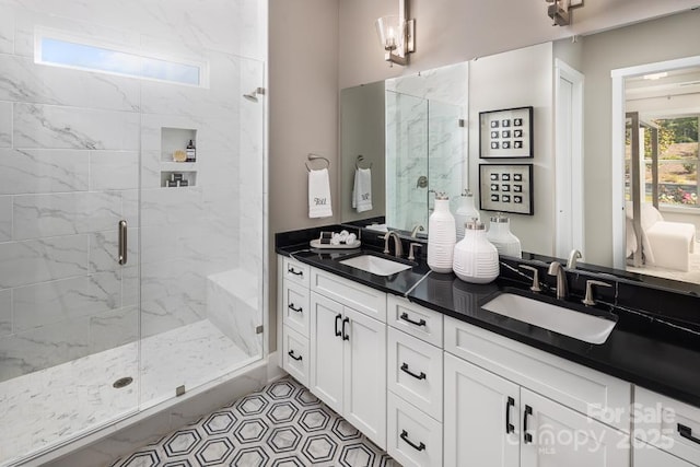 bathroom featuring tile patterned flooring, a shower with shower door, and vanity