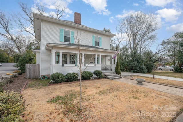 view of front facade featuring a front yard and covered porch