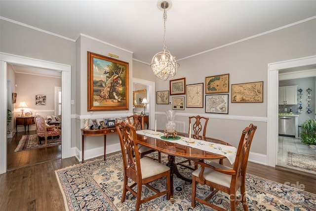 dining space with crown molding, a chandelier, and dark hardwood / wood-style flooring