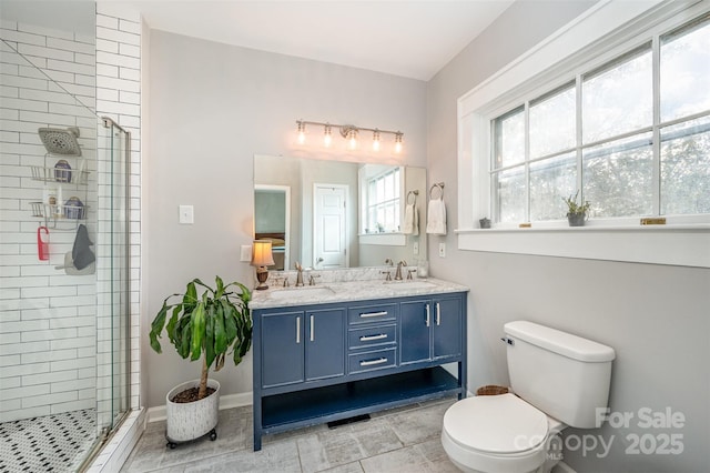 bathroom with vanity, toilet, tile patterned flooring, and a shower with door