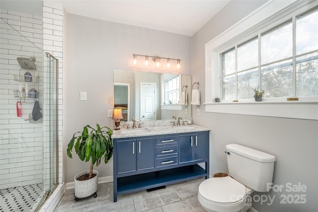 bathroom with vanity, toilet, tile patterned floors, and a shower with shower door