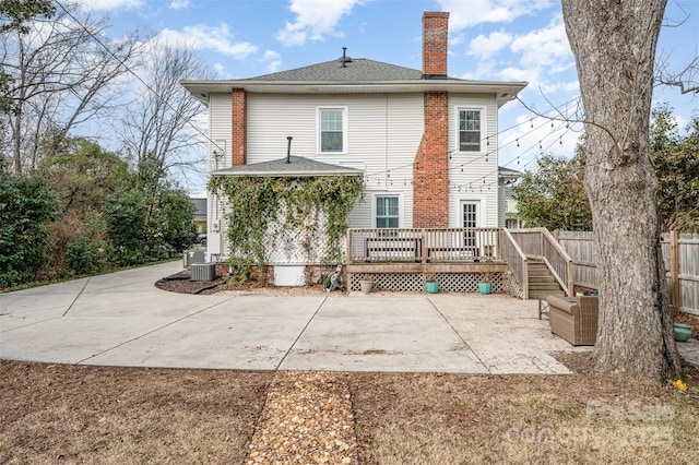 back of property featuring a wooden deck, central AC, and a patio