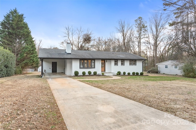 single story home with a carport and a front lawn