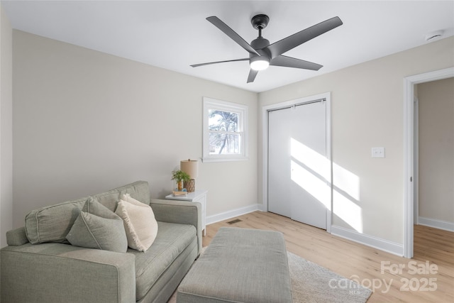 living area featuring ceiling fan and light hardwood / wood-style floors