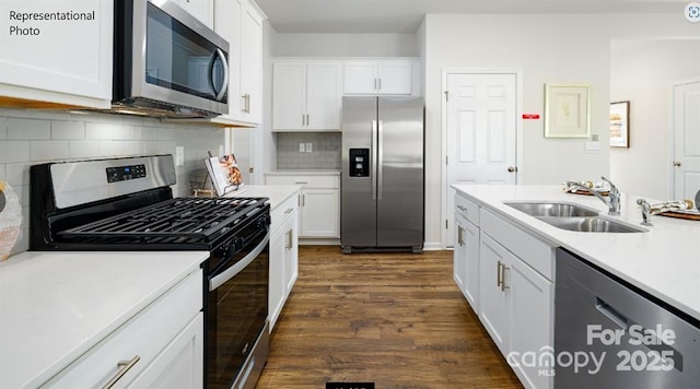 kitchen featuring appliances with stainless steel finishes, sink, and white cabinets